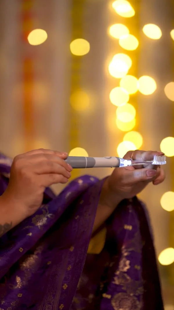 An ORACURA customer with their water flosser or electric toothbrush