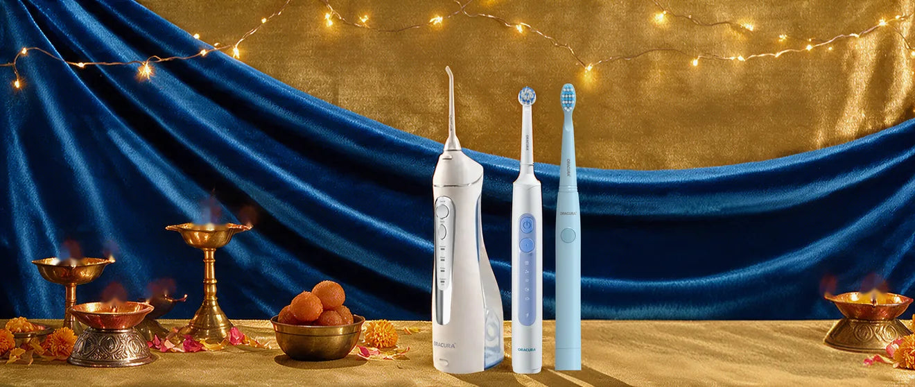 Oracura water flosser and toothbrushes on a festive blue-and-gold table