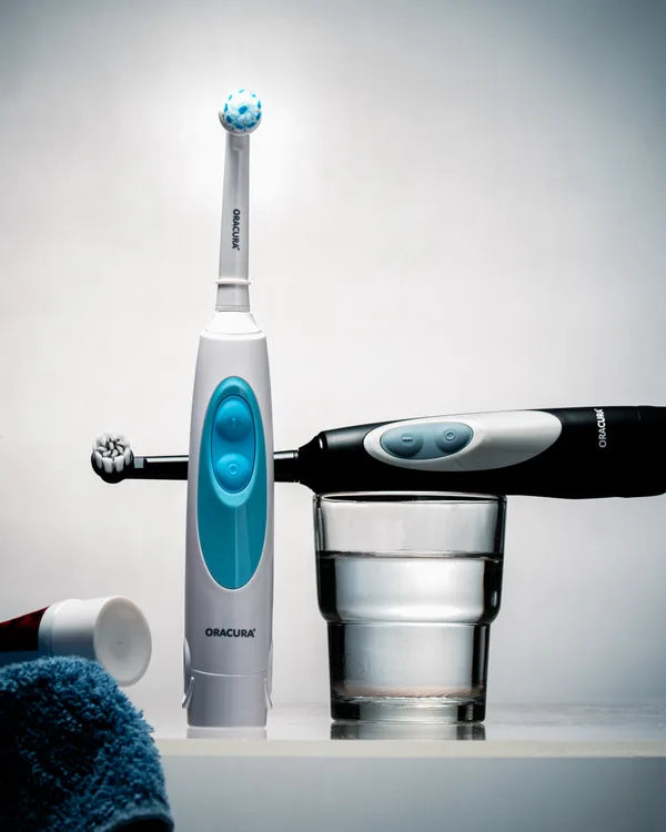 An ORACURA customer with their water flosser or electric toothbrush