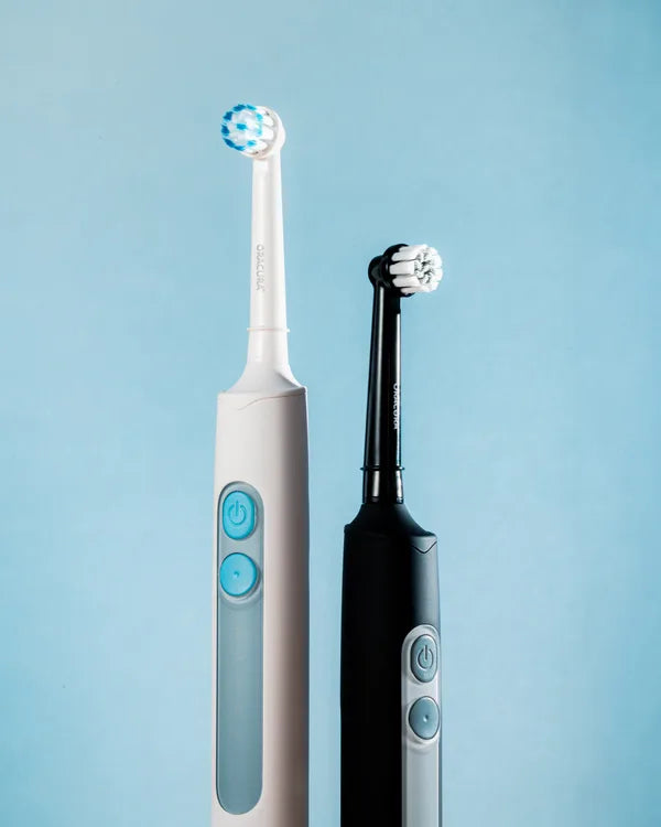 An ORACURA customer with their water flosser or electric toothbrush