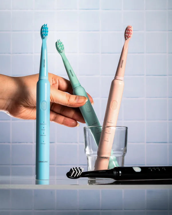 An ORACURA customer with their water flosser or electric toothbrush